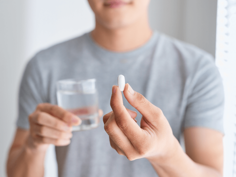 Man holding Weiprost capsule for prostatitis